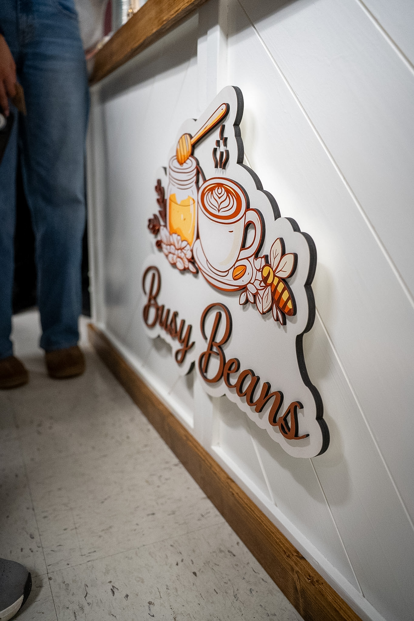 Close-up of the Busy Beans cart logo sign