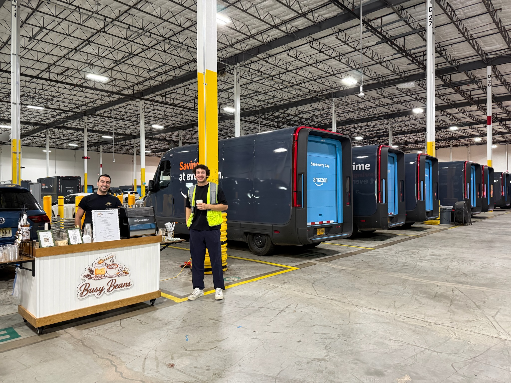 Busy Beans cart set up inside an Amazon delivery depot with a driver on a coffee break