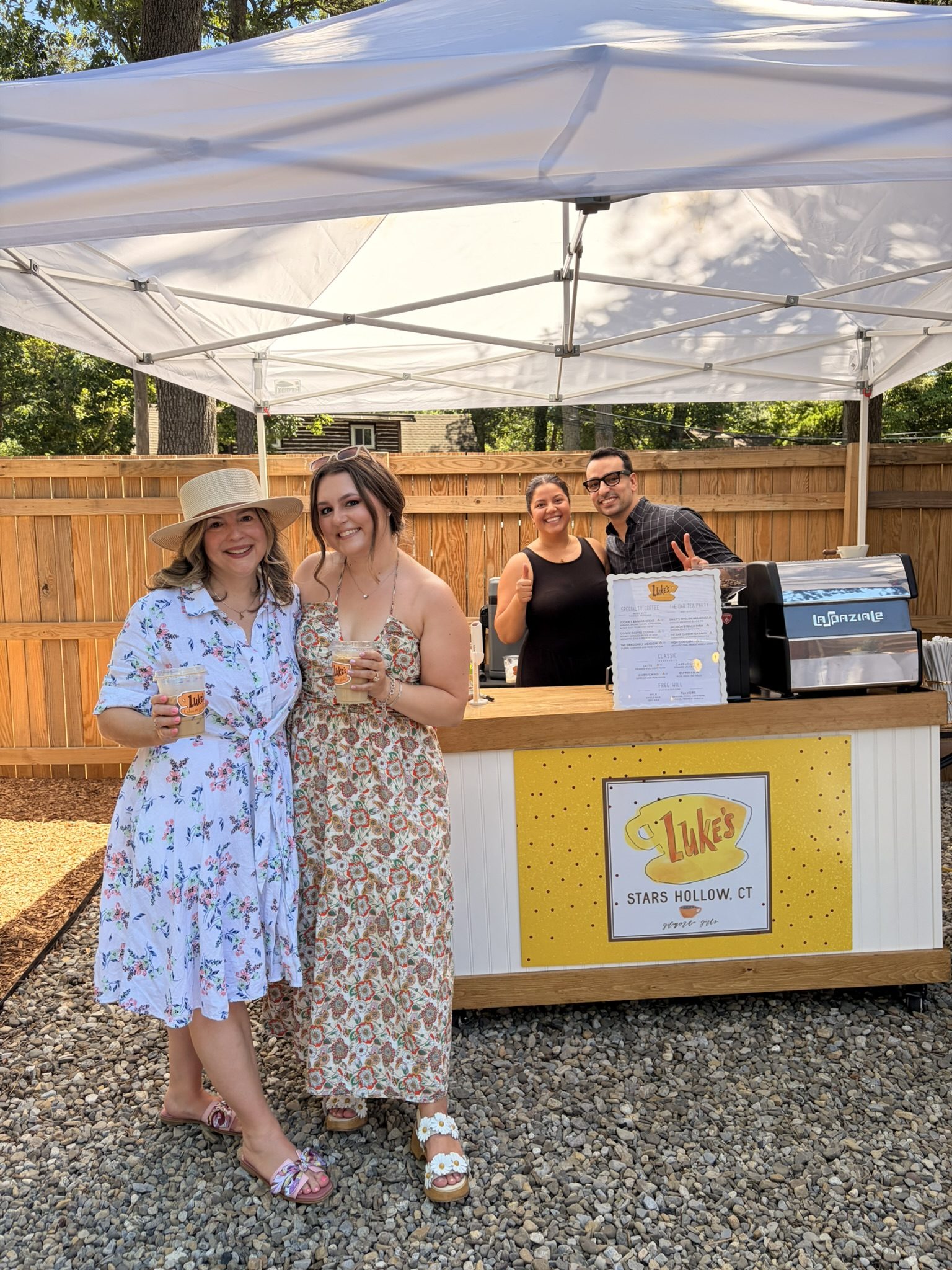 Guests and the Busy Beans barista team at a custom-themed coffee cart